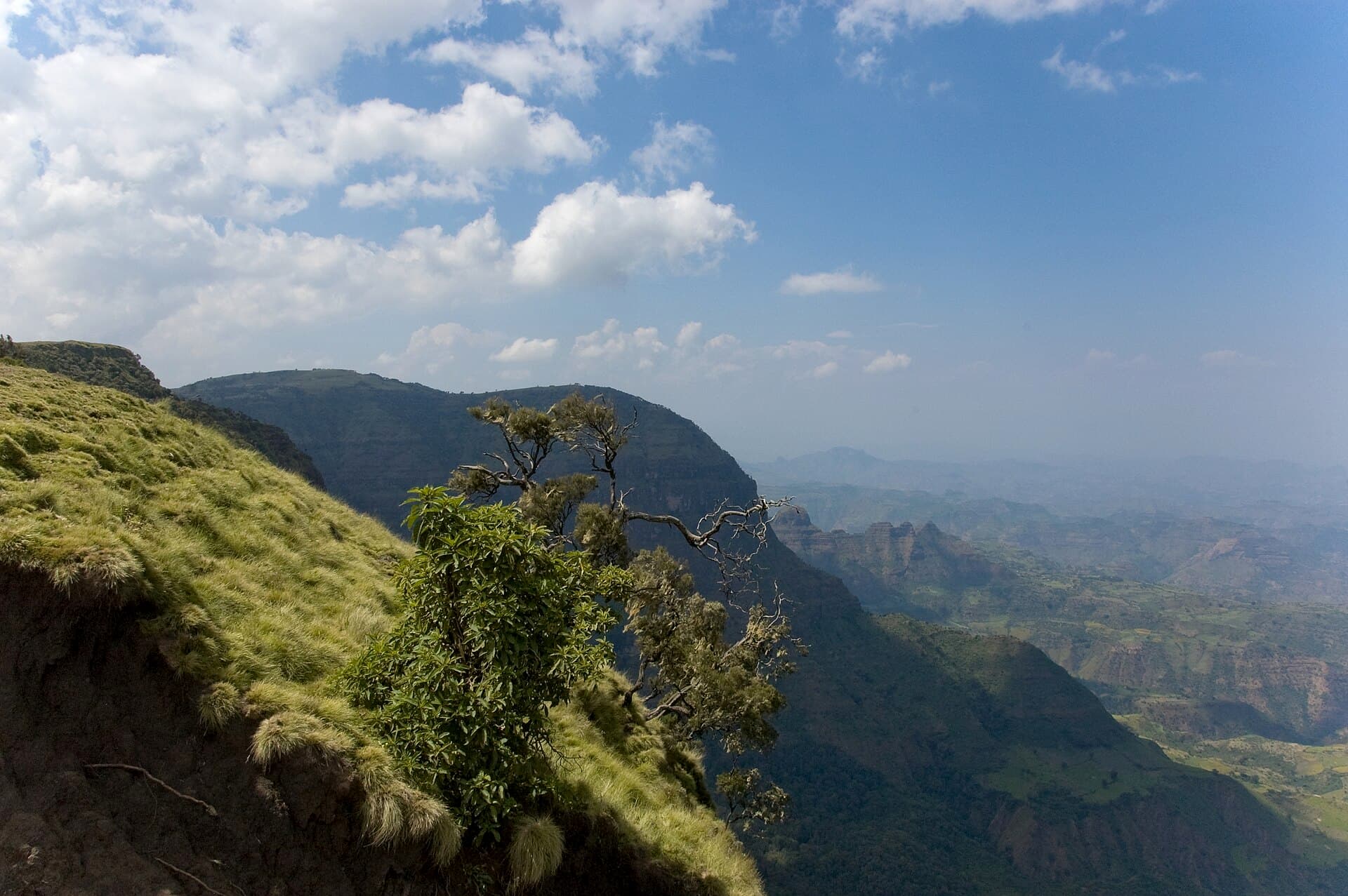 Green highland ridges of the Simien Mountains under a wide sky