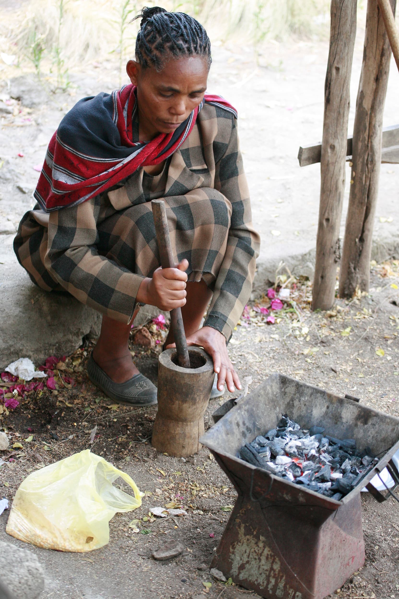 Woman pouring coffee from a jebena during an Ethiopian coffee ceremony